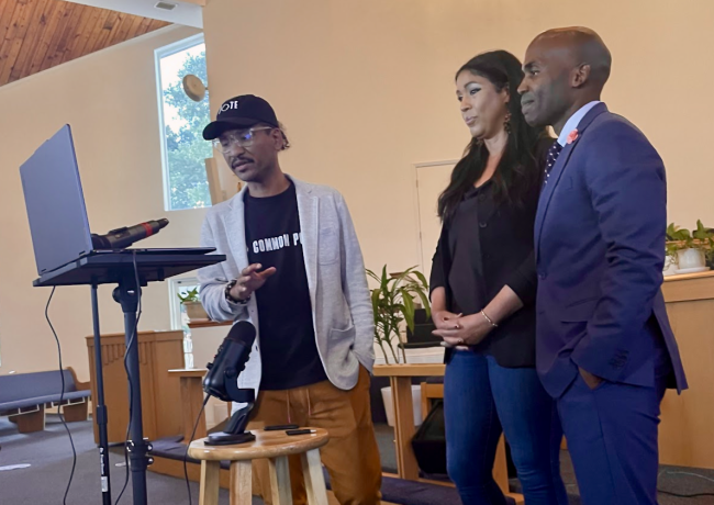 Three individuals stand inside a church during a 24-hour teach-in last week.