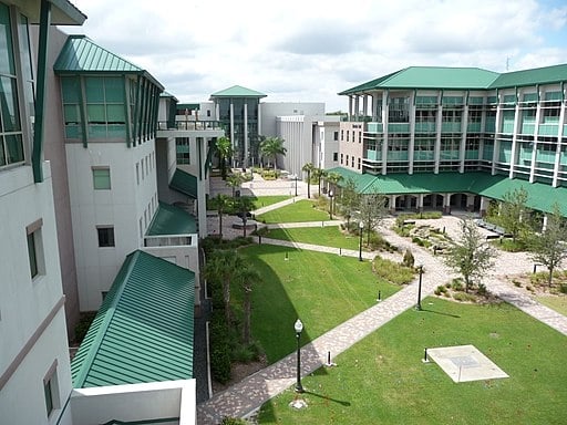 The Florida Gulf Coast University campus: buildings surround a rectangular grassy area.