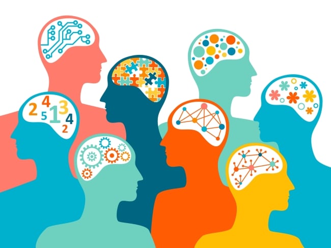 An illustration of brains of different colors with different patterns inside them, such as puzzle pieces, numbers or flowers, to represent neurodiversity.  