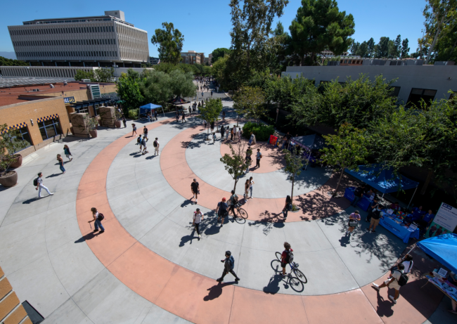 Students walk around on the University of California, Irvine, campus
