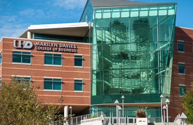 A picture of a brick and glass building with Marilyn Davies College of Business on the side.