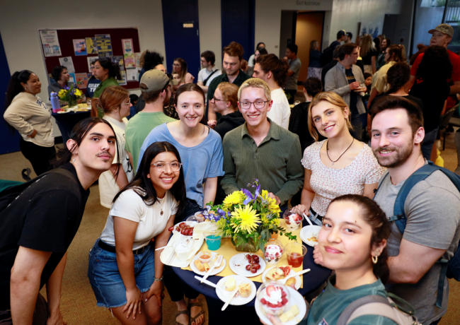 Oregon Tech students smile for a photo at a dessert reception.