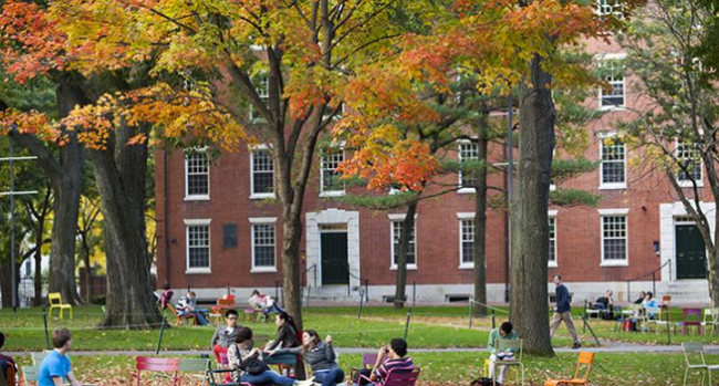 Harvard building with trees full of autumn leaves