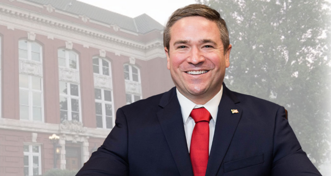 Andrew Bailey, a white man wearing a business suit and red tie