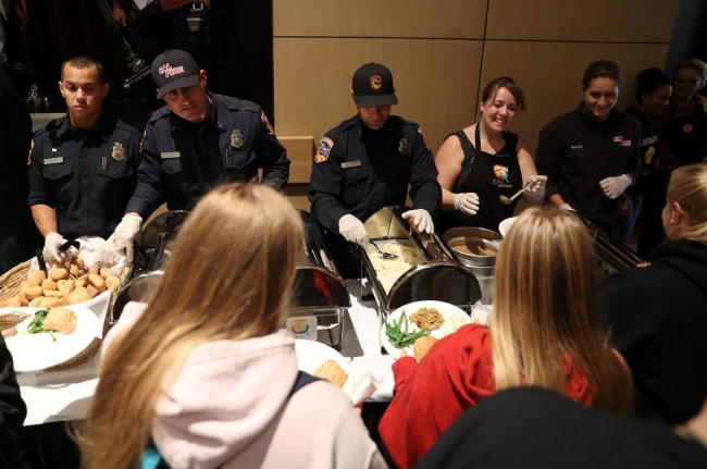 Cal Fire firefighters serve Camp Fire evacuees during a community Thanksgiving dinner at California State University, Chico 