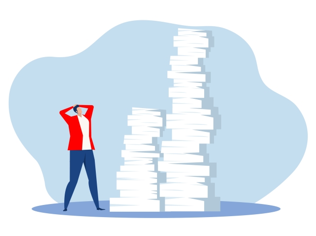 A person stands in front of two huge stacks of manuscripts with their hands on their head (opinion)