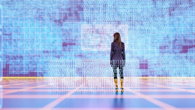 Woman stands before a wall of scientific data
