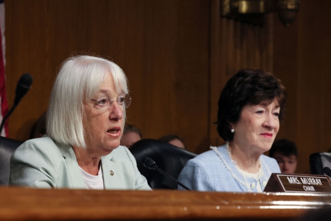 Washington senator Patty Murray, a Democrat, sits on the dais next to Maine senator Susan Collins, a Republican. The two lawmakers lead the Senate appropriations committee.