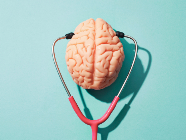 An image of a stethoscope and a human brain, depicting the concept of mental health.