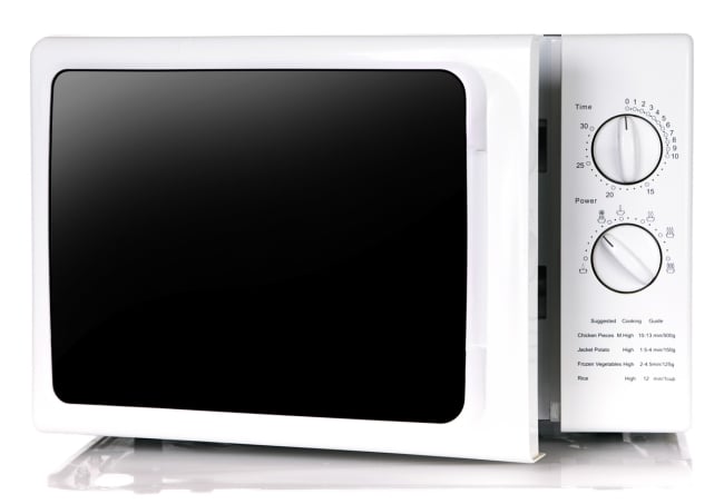 A white microwave with two large knobs.