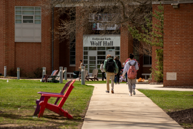 Students walk on York College's campus on a sunny day.