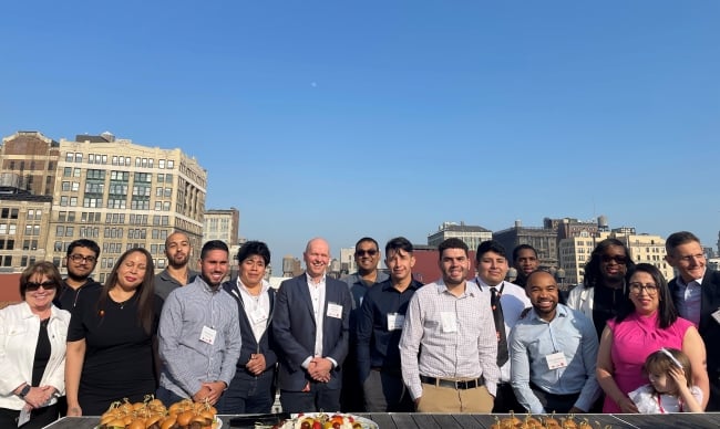 LaGuardia Community College students smile for a photo on a rooftop in Manhattan.