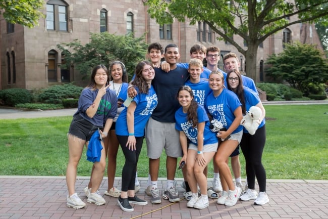 A group of first-year students smile for a photo on Wear Blue Day at Seton Hall University.