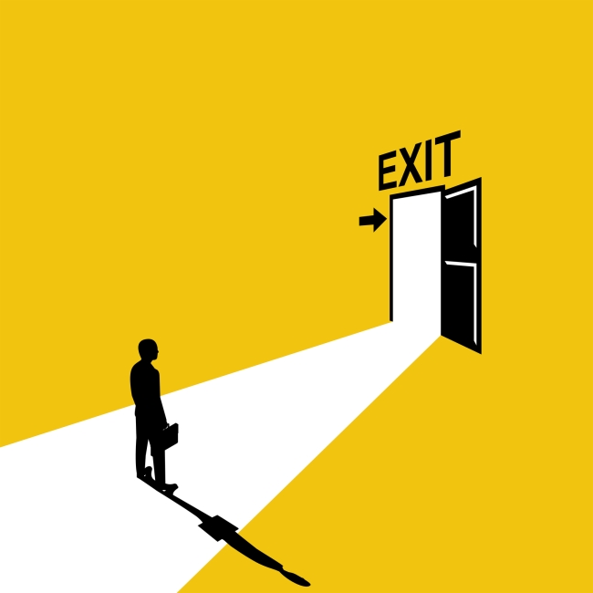 Person holding briefcase stands alone before open door above which a sign reads "Exit"