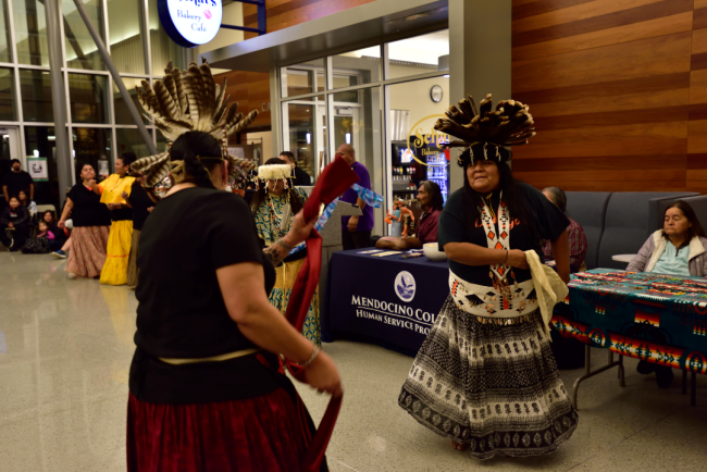 Two Pomo dancers wear traditional regalia at Mendocino College's Native American Day.