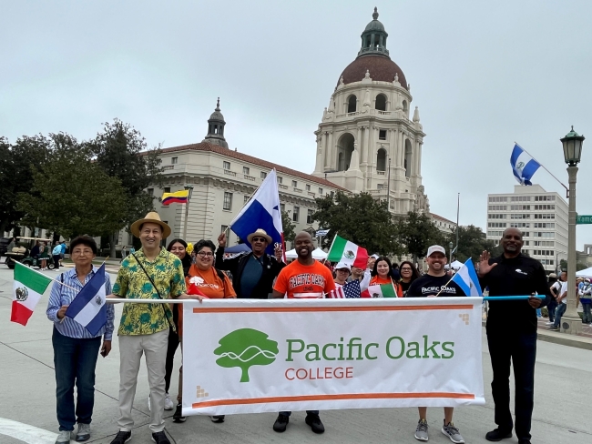 Pacific Oaks faculty, staff and students hold a banner during the Latino Heritage Parade and Festival in Pasadena.