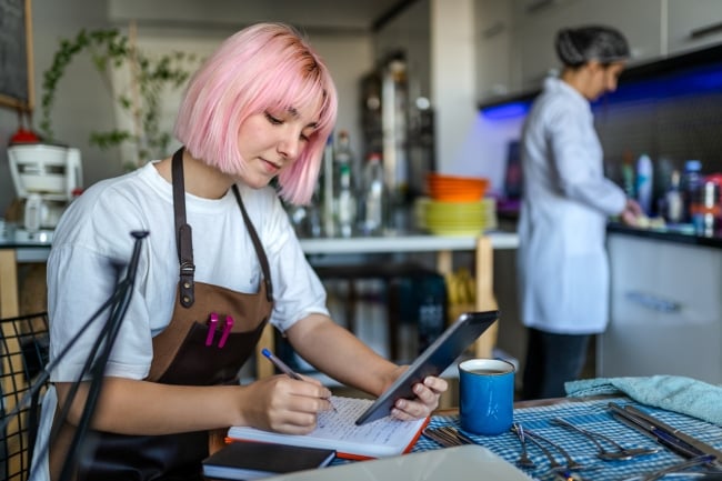 College students working at cafe while completing coursework