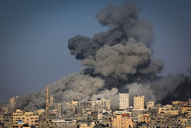 An overhead view of smoke billowing over Gaza City in the aftermath of Israeli air strikes. 