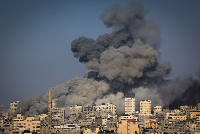 An overhead view of smoke billowing over Gaza City in the aftermath of Israeli air strikes.