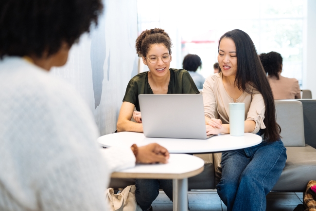 Tech university students in campus using laptop after lectures in the lobby in campus.