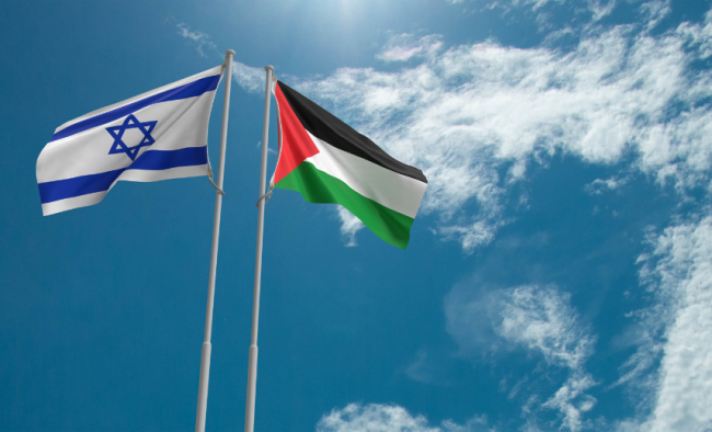 The flags of Israel and Palestine, respectively, flying against a blue sky.