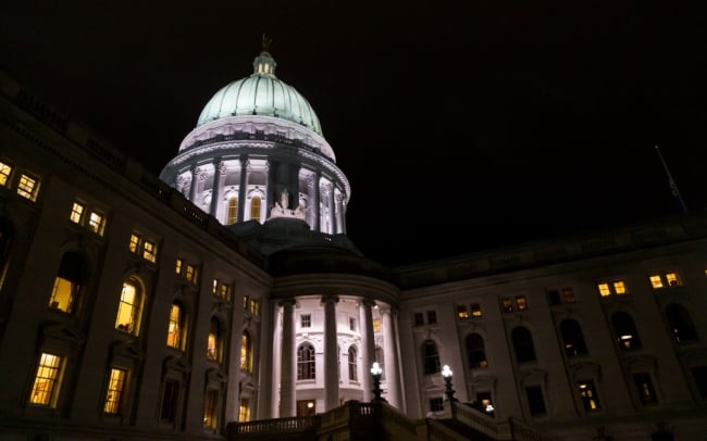 A state capitol building lit up at night