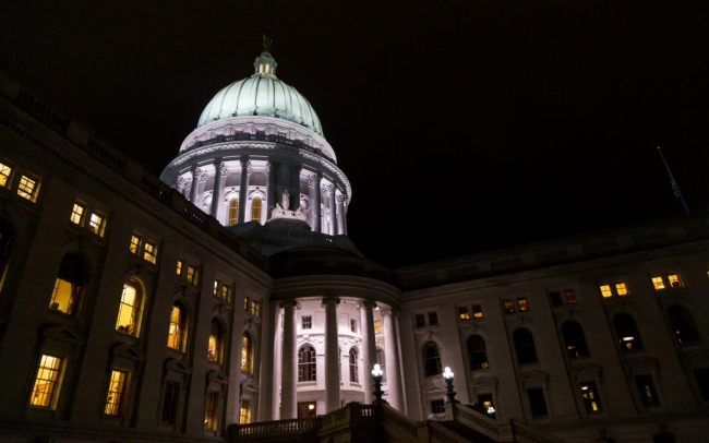 A state capitol building lit up at night