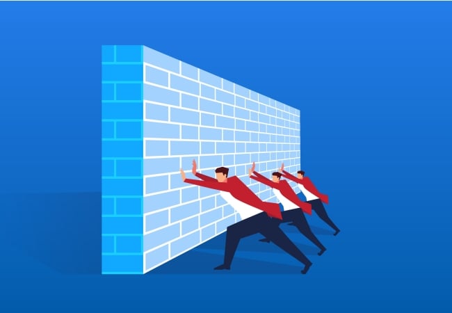 Three men push against a wall-like barrier