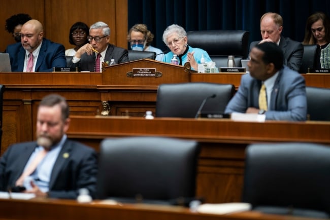 Virginia Foxx, in a bright teal sweater, sits on the dais during a committee hearing