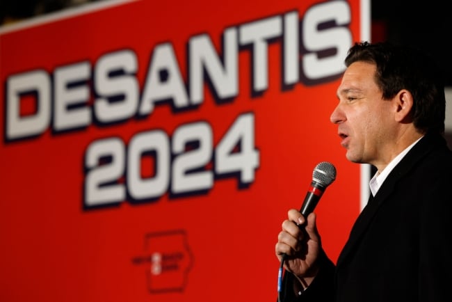 A photo of Florida governor Ron DeSantis in front of a sign proclaiming his 2024 presidential campaign