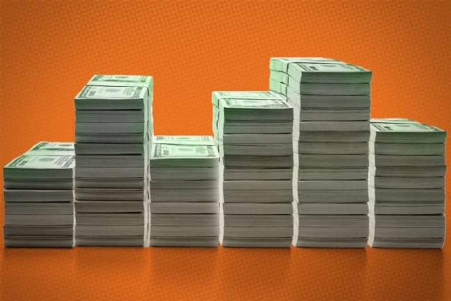 Photo illustration of piles of money.