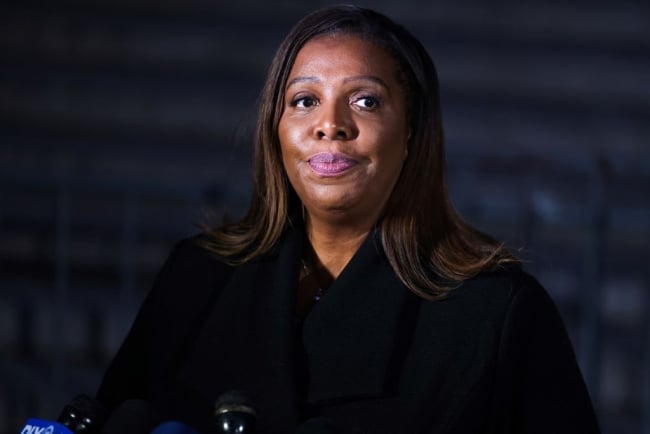 A Black woman stands in front of a podium, lips pursed.