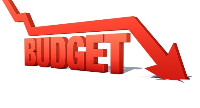 A graphic featuring a red arrow moving in a downward direction atop the word "BUDGET."