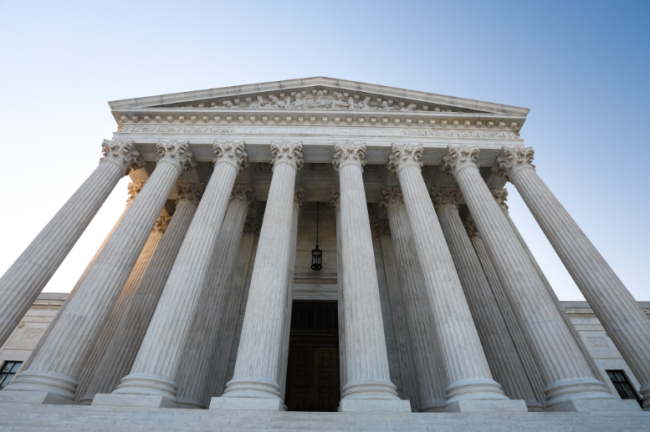 A frontal view of the U.S. Supreme Court building, with its eight columns.