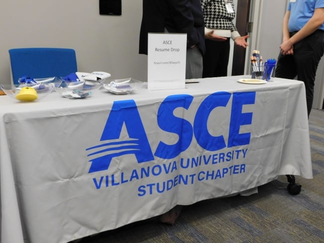A white-clothed table labeled Villanova University ASCE (for American Society of Civil Engineers) is set up for an event.