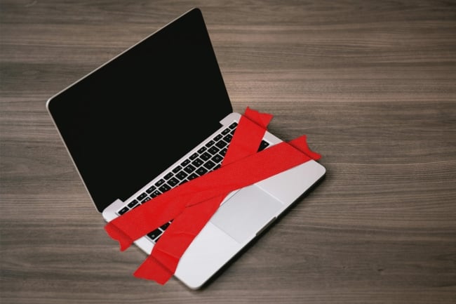 An illustration of a laptop covered in red tape