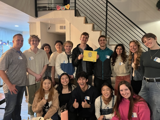 Students and alumni smile for a photo after a UCLA dinner.