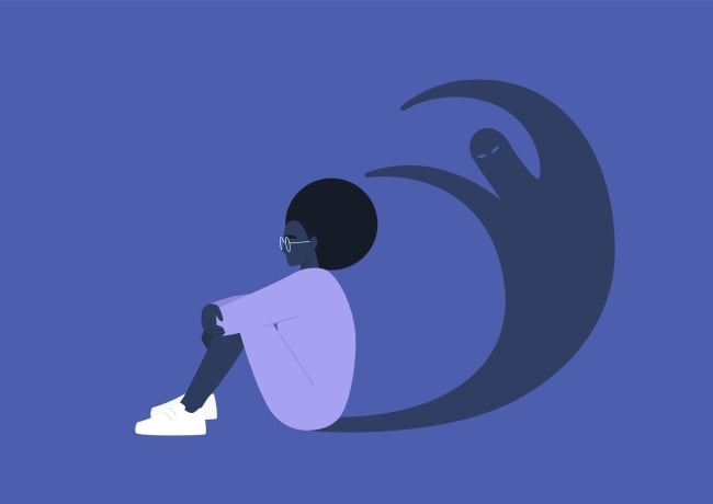 Black woman sits in front of her shadow, which is a ghost-like figure
