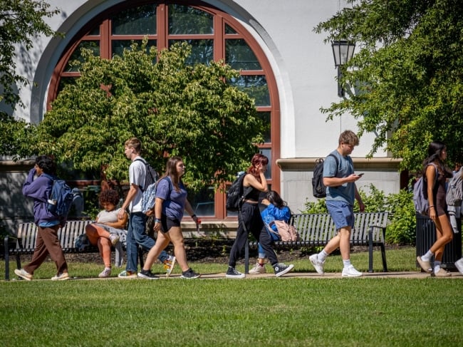 Students walk on Montclair State University’s campus on a sunny warm day