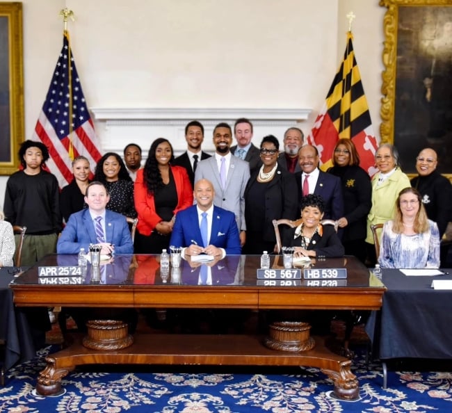 A photo of Maryland politicians, alongside Cameron Carden and his mother, Gay Green-Carden,at the signing of the Cameron Carden Act.