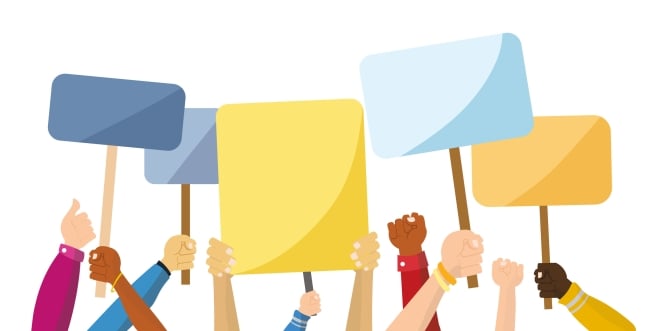 Hands of people of various races holding generic protest signs