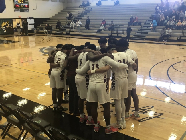 The South Arkansas College men’s basketball team huddles before a game.