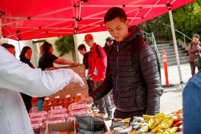 A student looks at a table of snacks at City College of San Francisco.