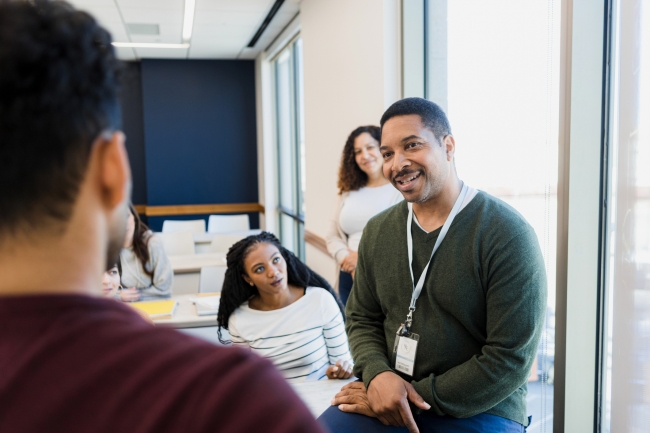 Adult teacher talks with a student