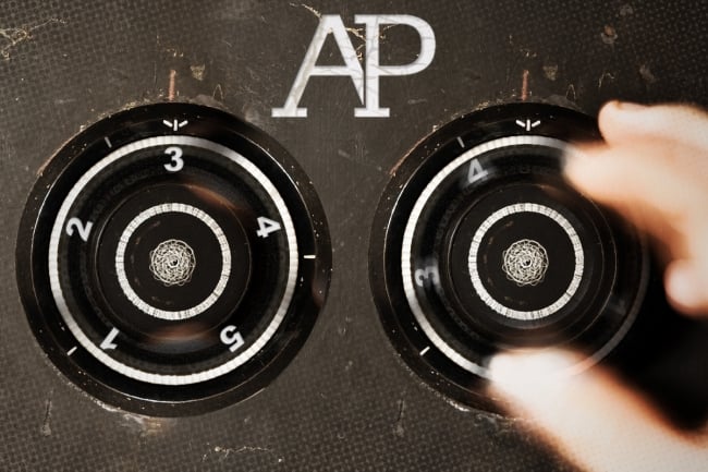Two safe locks, being turned to 3, with the letters AP engraved above