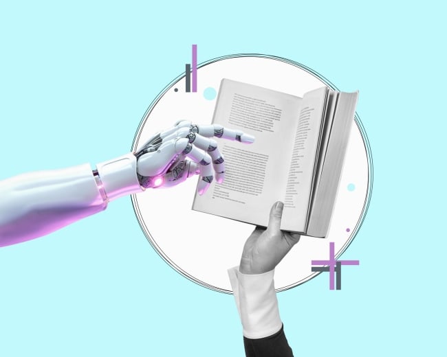 A robot hand points to a book. The book is being held by a human hand.