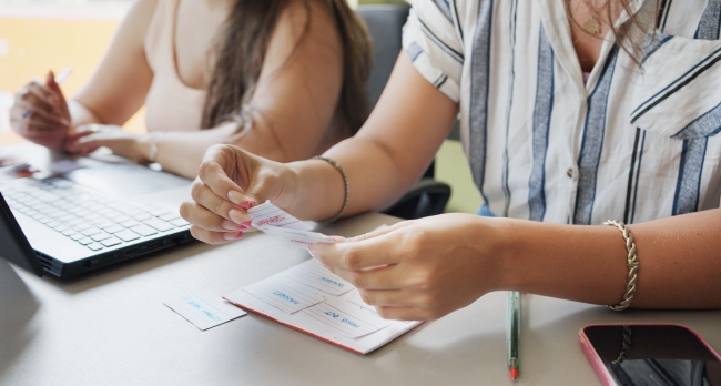 Two unidentified students study before class using flash cards