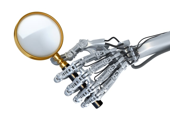 Robot hand holds magnifying glass as if to look closely and assess something