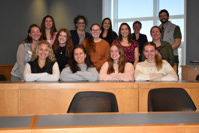 A group of student smile in a classroom