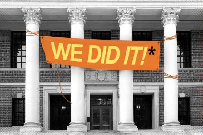 A sign saying "we did it" with an asterisk on a campus building